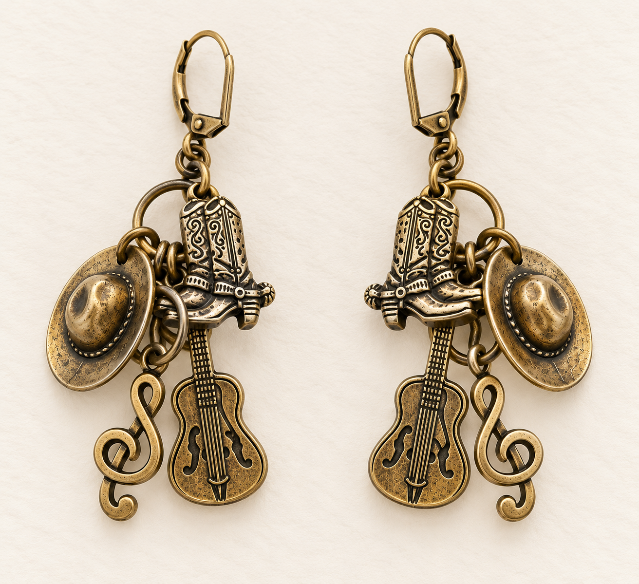 Western Charm Earrings featuring cowboy boots, hats, guitars and treble clefs in Antique Brass, handmade by Lorraine Frances Jewelry.